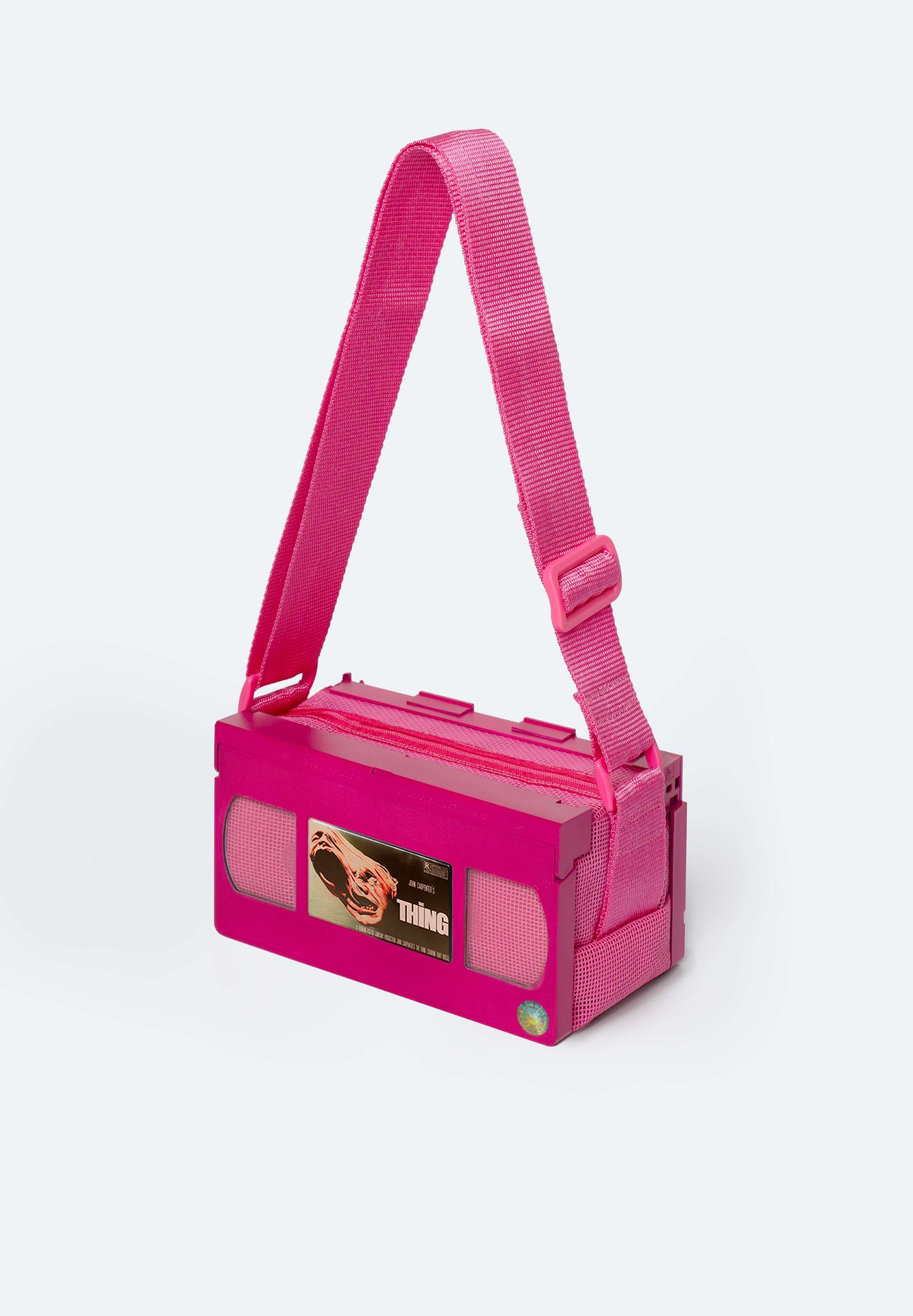 Fuchsia VHS Bag customized with the Thing inspired magnet, collectible Movie Charm for VHS bags, a nod to John Carpenter’s chilling sci-fi horror classic from the 80s