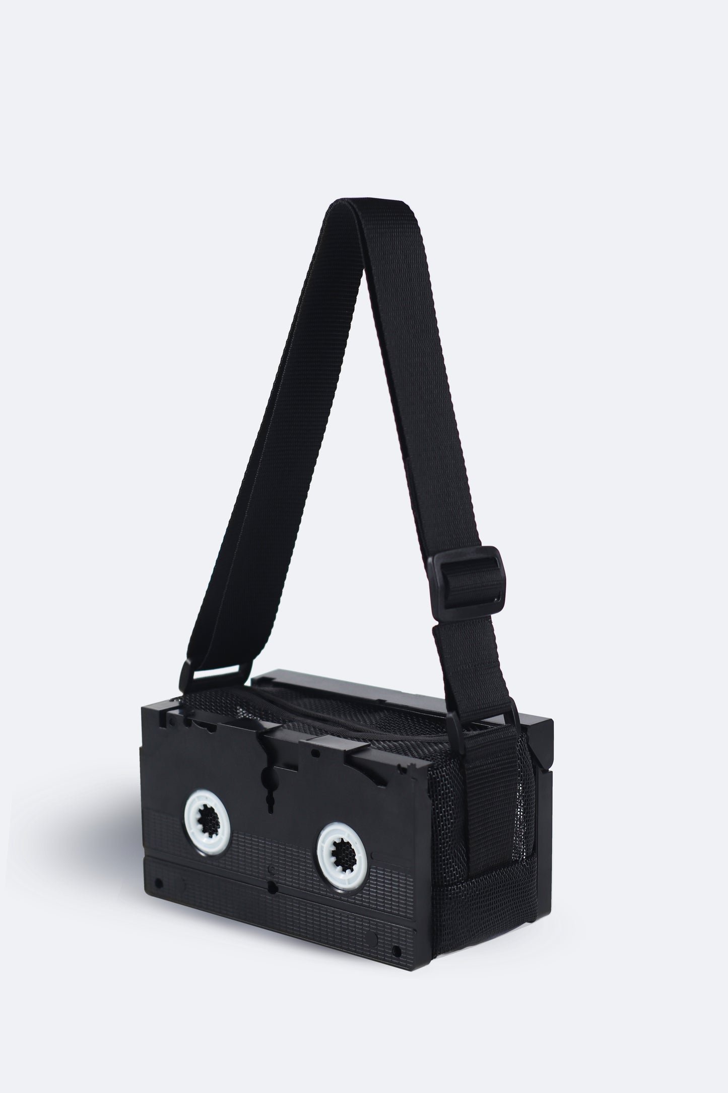 Back view of handmade black VHS bag from the Videoclub 2025 Collection by Pepita Chiringo, crafted from recycled materials, showcasing a sleek and minimalist design for movie lovers, sustainable fashion enthusiasts, and those seeking unique accessories inspired by cinematic nostalgia.