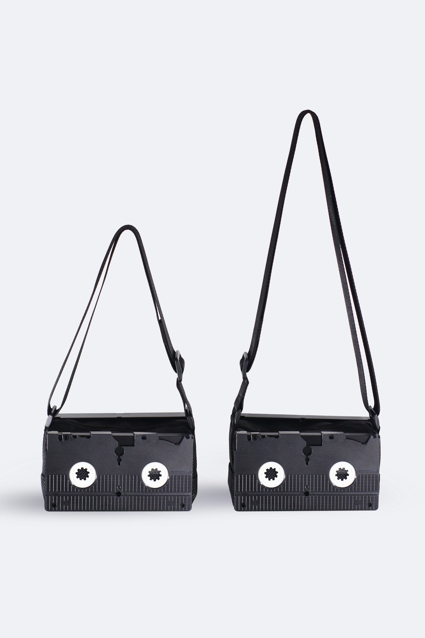 Comparison of the black VHS handbag from the Videoclub 2025 Collection by Pepita Chiringo, showing the adjustable strap in its maximum (crossbody bag) and minimum (shoulder bag) lengths, offering versatile styling options for movie lovers and sustainable fashion enthusiasts.