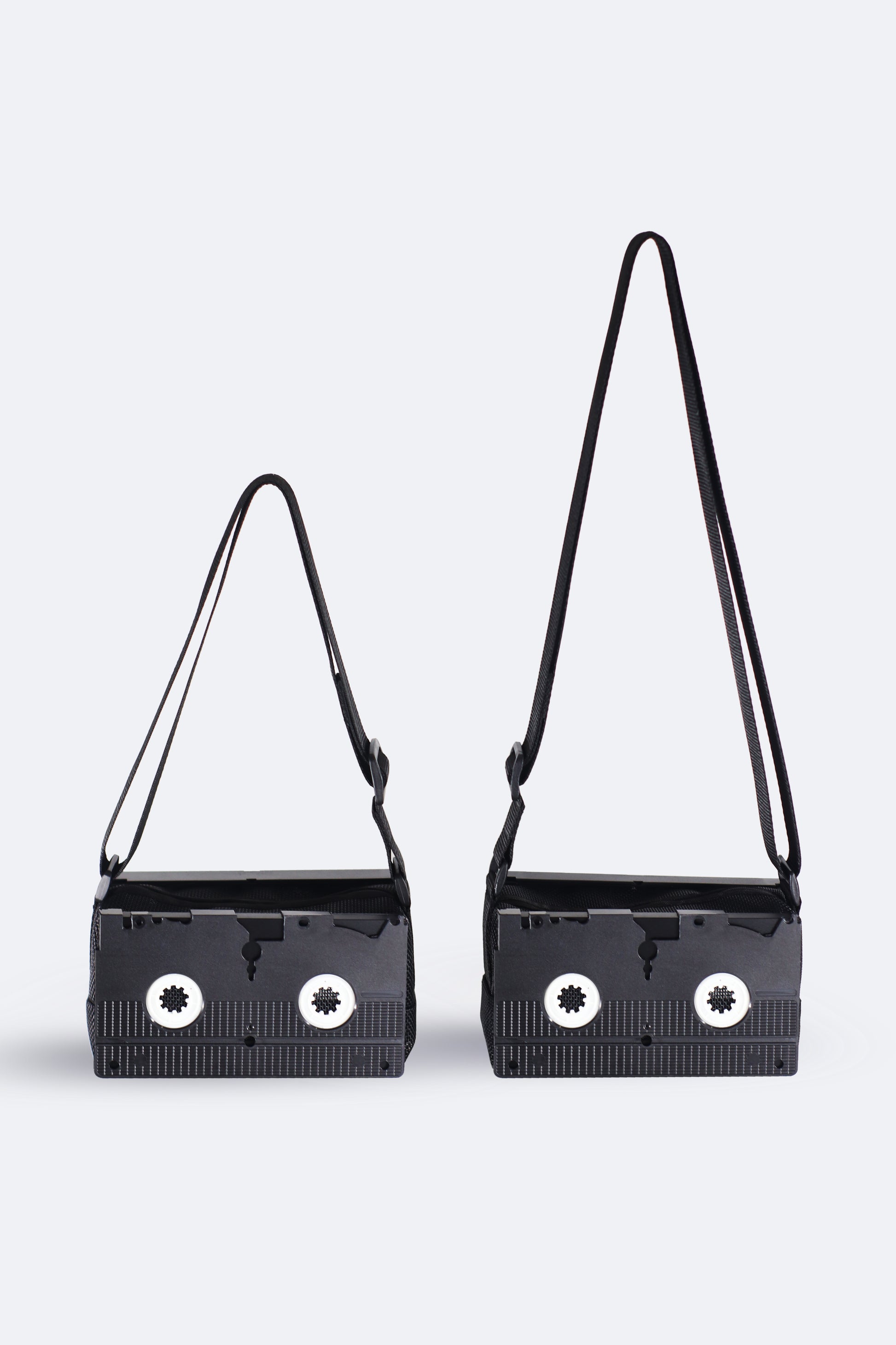 Comparison of the black VHS handbag from the Videoclub 2025 Collection by Pepita Chiringo, showing the adjustable strap in its maximum (crossbody bag) and minimum (shoulder bag) lengths, offering versatile styling options for movie lovers and sustainable fashion enthusiasts.